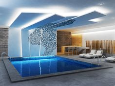 an indoor swimming pool with lounge chairs and water feature in the center, surrounded by stone walls