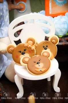 two teddy bears sitting in a white chair