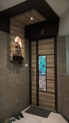 an open door leading to a bathroom with tile walls and flooring on both sides