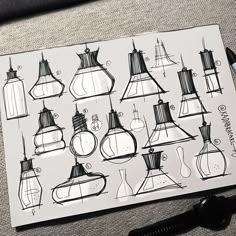 a bunch of lamps that are on top of a piece of paper next to some scissors