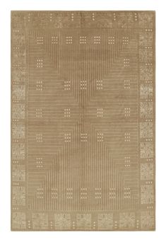 a beige rug with an intricate design on the front and back side, in shades of brown