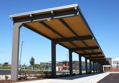 an empty covered parking lot in front of a building