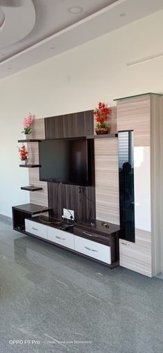 a living room with a flat screen tv and entertainment center