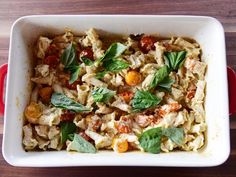 a casserole dish filled with pasta and vegetables