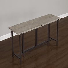 an empty table in a room with hard wood flooring