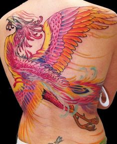 the back of a woman's body with colorful tattoos on her stomach and wings