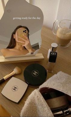 a woman taking a selfie with her cell phone in front of a vanity mirror