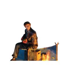 a man sitting on top of a wooden bench next to a fire