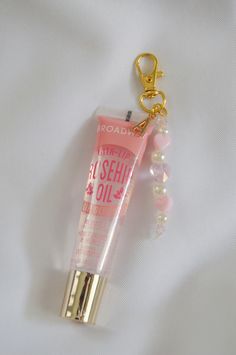 This lip gloss keychain is just the perfect accessory to personalize your beauty essentials or to gift to a friend. Attached to the lip gloss is a cute beaded charm and an initial charm of your choice.  Add this cute keychain to your keys, purse, or etc to have your lip gloss with you at all times.  D E T A I L S  - this keychain includes the lip gloss.  - Please note that due to photo editing, lighting, and screen settings, colors on the photos may be slightly different than the colors in perso Lip Gloss Decoration, Affordable Pink Glasses Chains For Gifts, Phone Key Chain, Lip Keychain, Diy Keychain Ideas, Dance Gift Ideas