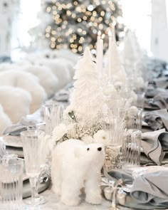 there is a table set with silver and white decorations