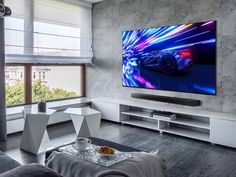 a large flat screen tv mounted to the side of a wall in a living room