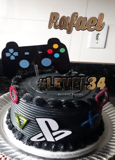 a birthday cake that is decorated with video game controllers and the words level 34 on it