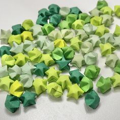 green and yellow origami stars scattered on white surface