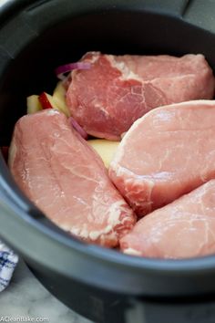 raw meat in a slow cooker ready to be cooked