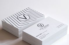 two business cards sitting on top of each other