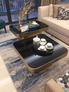 a living room filled with furniture and a glass coffee table on top of a rug