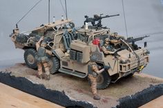 a toy army vehicle with soldiers on it