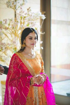 a woman in an orange and pink outfit