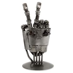 a metal sculpture of a robot with four lights on it's head and arms