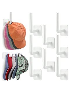 six pairs of hats hanging from hooks on a white wall with five different colors and sizes