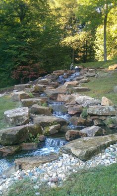 there are many rocks and water flowing down the hill