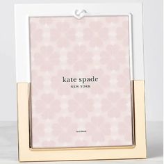 the kate spade new york photo frame is shown in white and gold with pink flowers