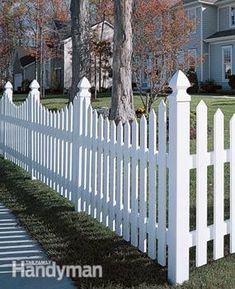 a white picket fence in front of a house