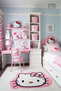 a bedroom decorated in pink and white with hello kitty rug