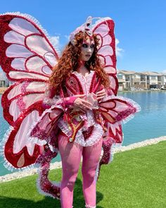 a woman in pink and white costume standing on grass