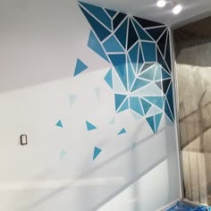 a bathroom with blue and white tiles on the wall