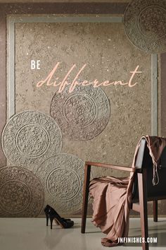 a chair sitting in front of a wall with the words be different on it