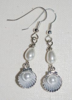 Handmade Earrings: Silver Scallop Shells with PearlsI found these little vintage silver metal scallop shells with the pearls already in them and added the teardrop-shaped pearls to take them to the next level.  I hope you like them...I think they are adorable!The charm is 1.25" long; the earring from the top of the hypo-allergenic ear wire to the bottom of the shell is 2" long. Diy Earrings Easy, Nautical Earrings, Coquille Saint Jacques, Sea Jewelry, Seashell Jewelry, Hand Painted Jewelry, Saint Jacques, Scallop Shells, Seashell Crafts