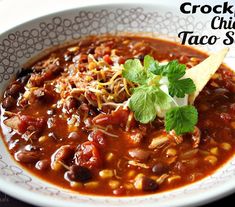 a white bowl filled with taco soup and garnished with cilantro