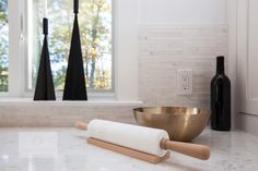 a kitchen counter with rolling pin and wine bottle