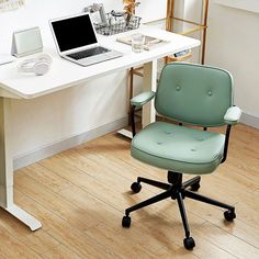 an office desk with a laptop computer on it and a chair in front of it