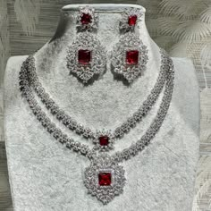 Handmade Style: Necklace and Earrings Set Material: Platinum Plated, Lab Simulated Ruby and White Sapphire Stones Imported Size: Earrings measure 2.25 inches long. Please Note: This necklace and earrings are sold as a set. Item Number: 7079 Long Diamond Necklace Set, Luxury German Silver Necklace For Ceremonial Occasions, Diamond Necklace Set Bridal, Bridal Diamond Necklace Design, Layered Diamond Necklace, Diamond Ruby Necklace, Ruby Necklace Set, Long Diamond Necklace, Lorraine Schwartz Jewelry