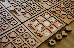 several pieces of paper cut out to look like flowers and hearts on a wooden table