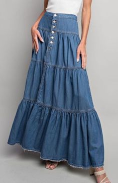 Solid denim maxi skirt featuring a half button down front, elastic in the back for added comfort, a ruffled and tiered body, a frayed bottom hem, and added seams and pleats for detail. Cheap Ruffled Denim Skirt For Spring, Cheap Denim Skirt With Ruffles, Cheap Flared Maxi Skirt With Ruffles, Double Layer Ruffle Jeans, Denim Long Skirt Outfit, Outfits Wide Leg, Blue Skirt Outfits, Clothes Outfits Ideas, Jeans Inspiration