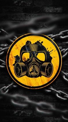 a yellow and black sign with a gas mask on it's face is surrounded by chains