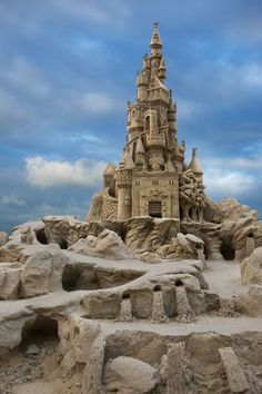 a sand castle made out of rocks on the beach