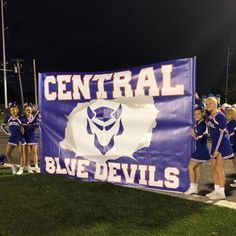 the cheerleaders are posing for a photo on the sidelines during a football game