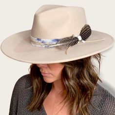 The Amelia is made from 100% Australian wool felt and has a classic wide cut brim, featuring a jute rope tie and feather trim. Details 100% Australian wool felt Brim: 3.75"Crown: 4.5"Size: O/S with a size adjuster for customizable sizing capability. The velcro ribbon size adjuster is tucked into the sweatband on the inside of the hat. How to clean: Spot clean using a damp cloth and mild soap. Air dry in an area free from direct sunlight. Bohemian Wool Fedora Felt Hat, Adjustable Beige Fur Felt Fedora, Bohemian Fur Felt Fedora Hat, Bohemian Fur Felt Fedora, Bohemian Fur Felt Hat With Flat Brim, Adjustable Bohemian Wool Hat, Bohemian Wide Brim Wool Felt Hat, Spring Fedora Hat Band In Fur Felt, Bohemian Fur Felt Hat With Adjustable Fit