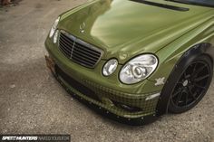 the front end of a green mercedes benz