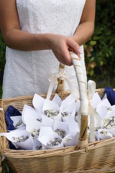 a woman holding a basket filled with white flowers