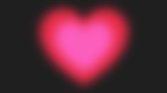 a red heart shaped object in the middle of a black background with light coming from it