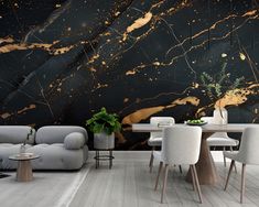 a modern living room with black and gold marble wallpaper, white chairs and a table