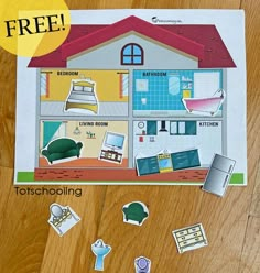 a cut out of a house with lots of stickers on the floor next to it