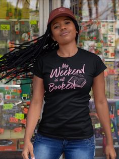 a woman wearing a t - shirt that says my weekend is books written on it