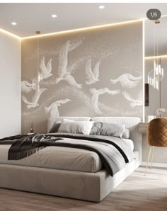 a large bed sitting next to a wall with birds on it