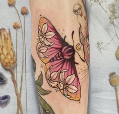 a colorful butterfly tattoo on the leg